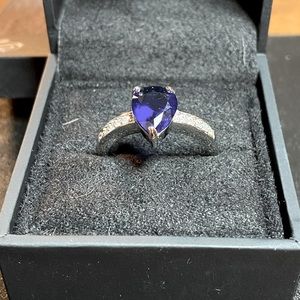 Sapphire stone on sterling silver band with white stones